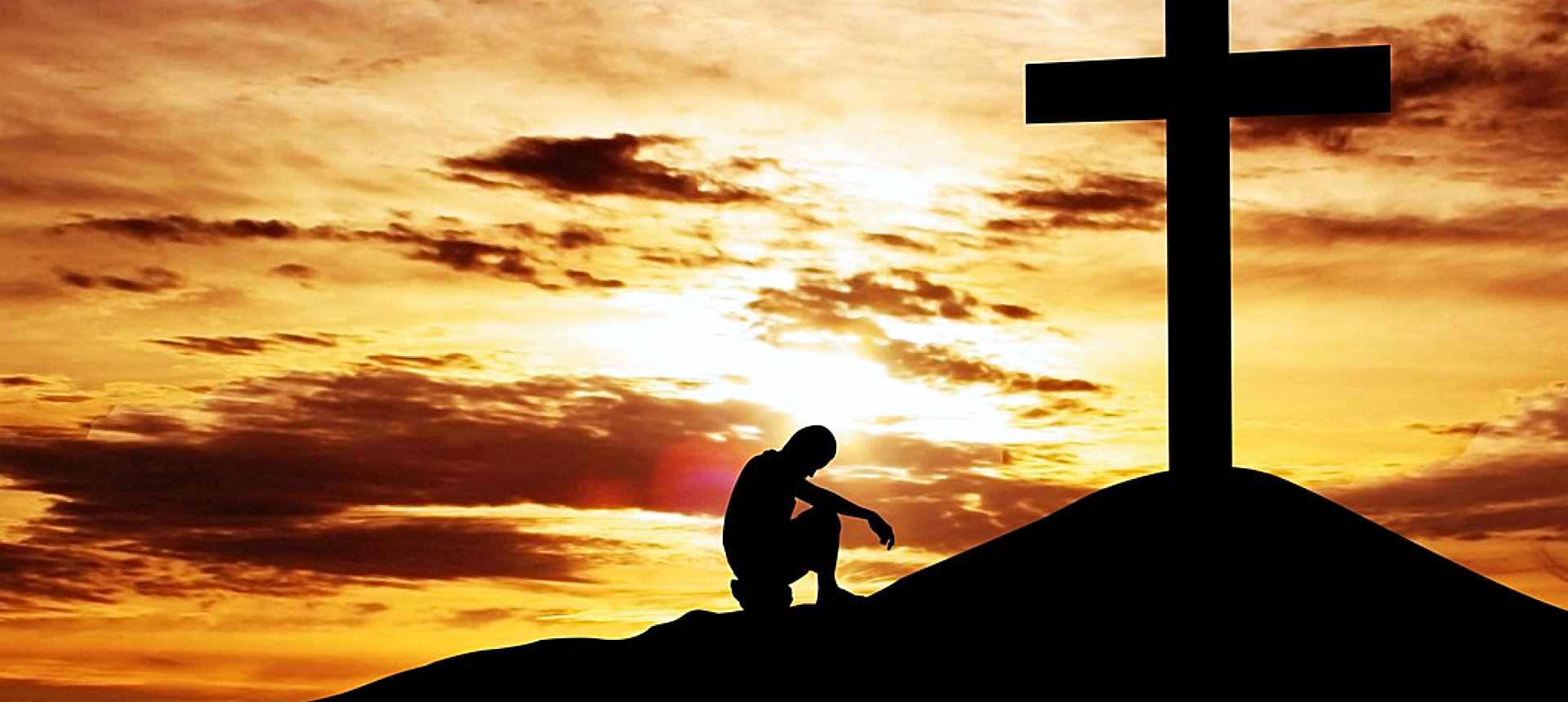 man kneeling on the cross